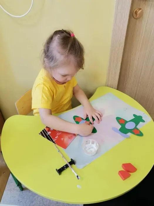 Ребёнок приклеивает звездочку